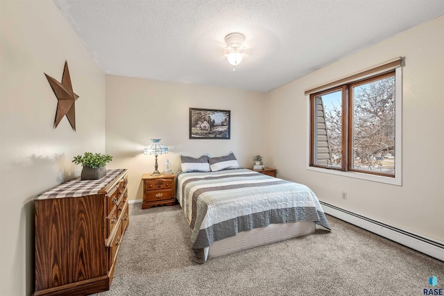 carpeted bedroom featuring ceiling fan, a textured ceiling, and a baseboard heating unit