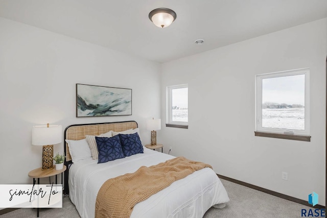 carpeted bedroom with multiple windows