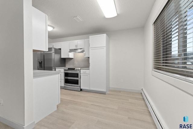 kitchen with white cabinets, a textured ceiling, stainless steel appliances, and tasteful backsplash