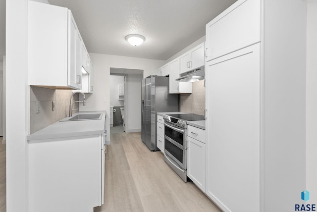 kitchen featuring white cabinets, sink, light wood-type flooring, and stainless steel appliances