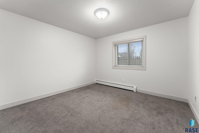 carpeted empty room with a baseboard radiator and a textured ceiling