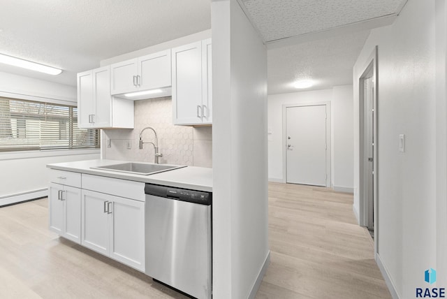 kitchen featuring decorative backsplash, white cabinetry, stainless steel dishwasher, and sink