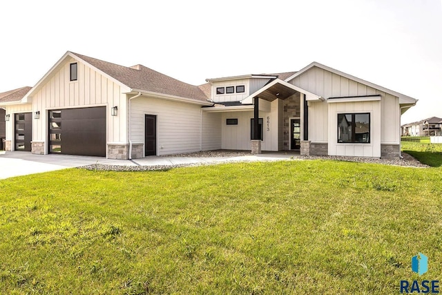 modern farmhouse featuring a garage and a front lawn