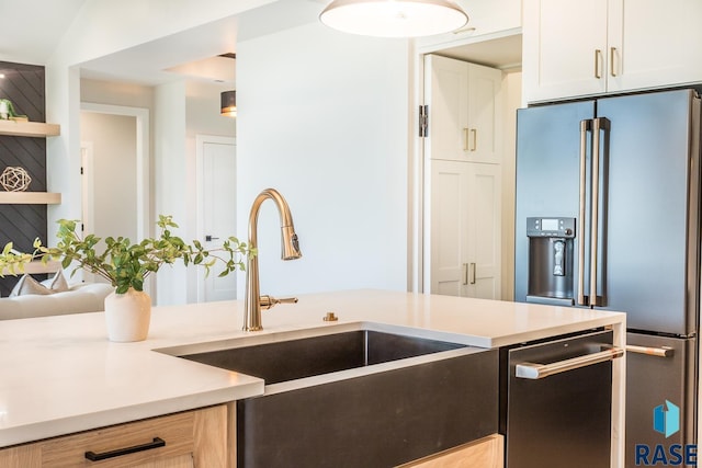 kitchen with white cabinetry, sink, and appliances with stainless steel finishes