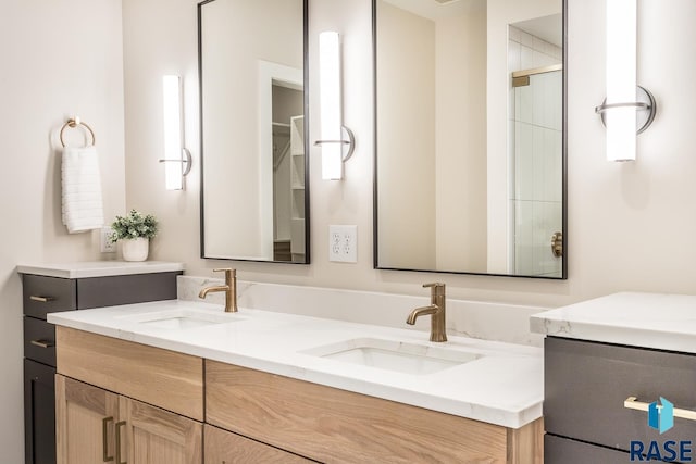 bathroom featuring vanity and an enclosed shower