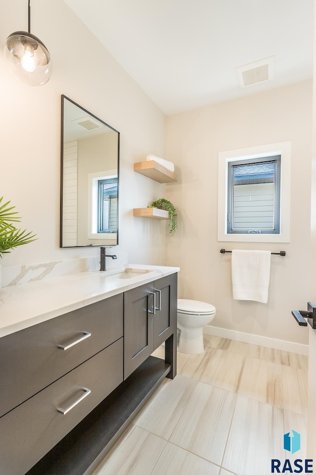 bathroom with vanity and toilet