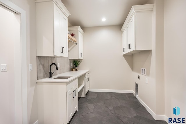 washroom featuring electric dryer hookup, cabinets, sink, and hookup for a washing machine