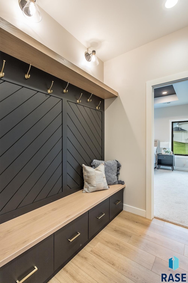 mudroom with light hardwood / wood-style flooring