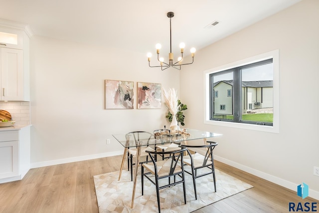 dining room with a chandelier and light hardwood / wood-style floors