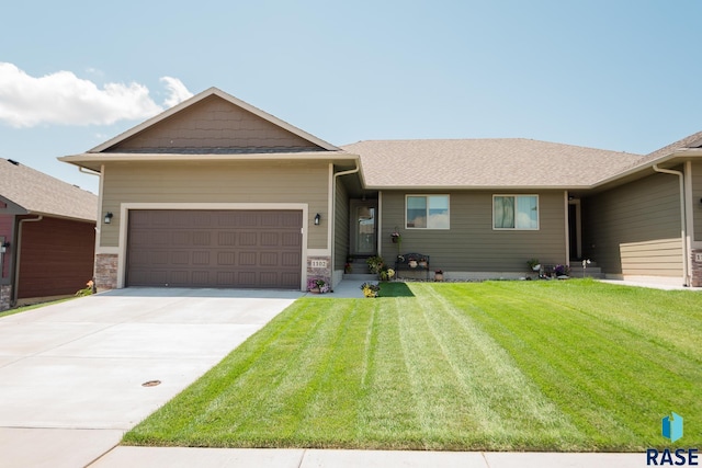 view of front facade with a garage and a front lawn