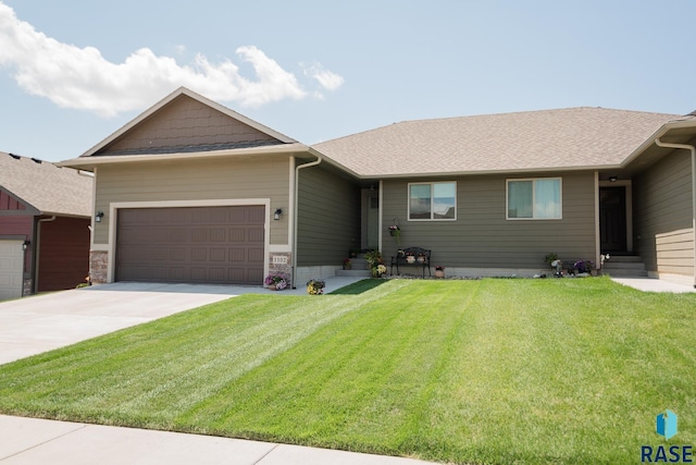 ranch-style home with a garage and a front yard