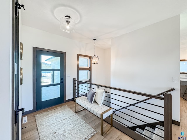 interior space with an inviting chandelier and light wood-type flooring