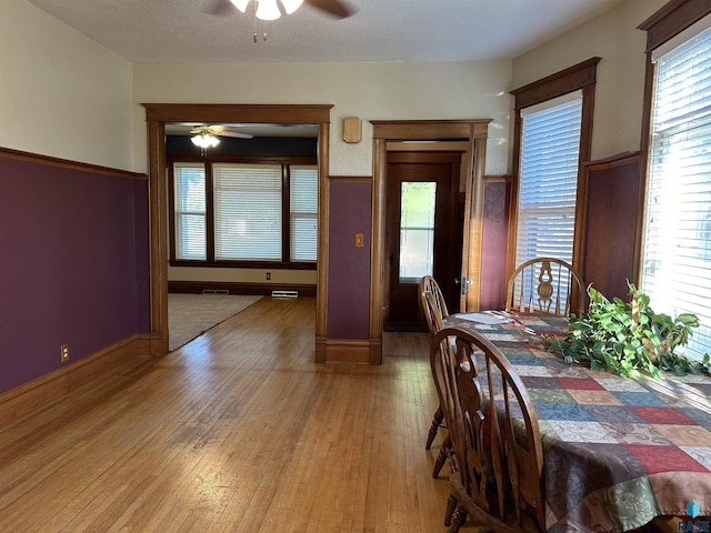 unfurnished dining area featuring hardwood / wood-style floors and ceiling fan