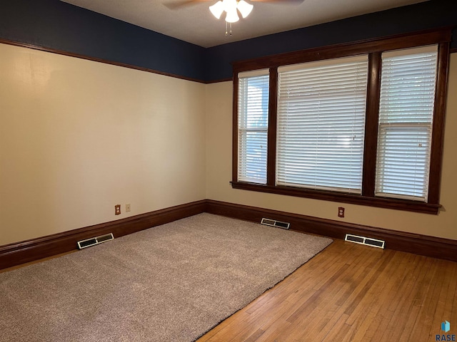 spare room featuring ceiling fan and hardwood / wood-style flooring