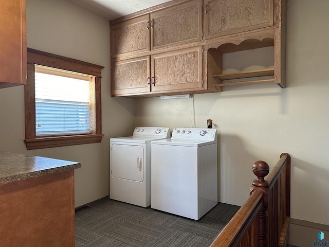 laundry area featuring washing machine and dryer and cabinets