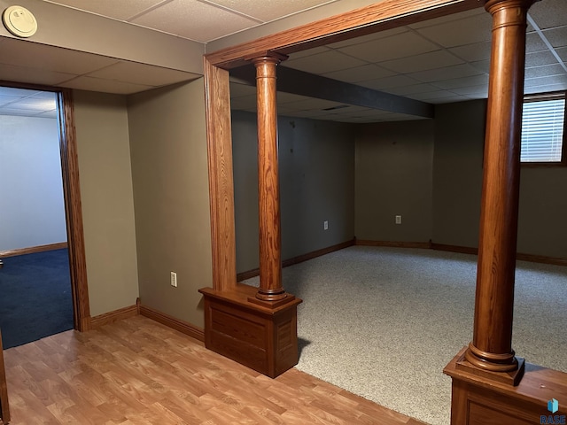 basement featuring light hardwood / wood-style floors and a drop ceiling