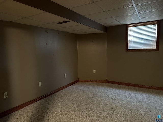 basement with carpet flooring and a paneled ceiling