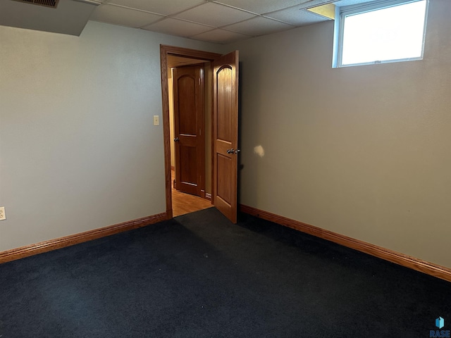 spare room with a drop ceiling and light colored carpet