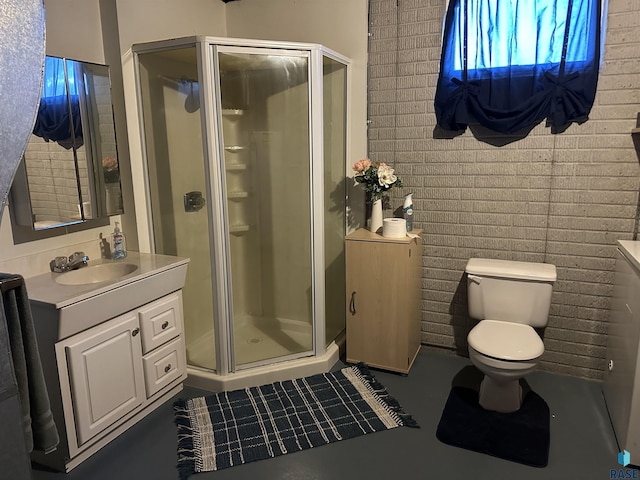 bathroom with vanity, toilet, and a shower with shower door