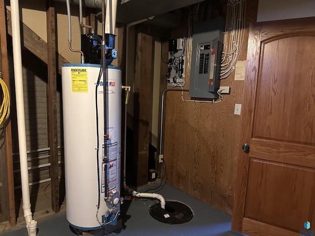 utility room with electric panel and gas water heater