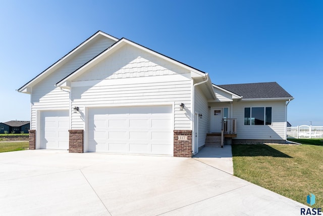 view of front of house with a front yard and a garage