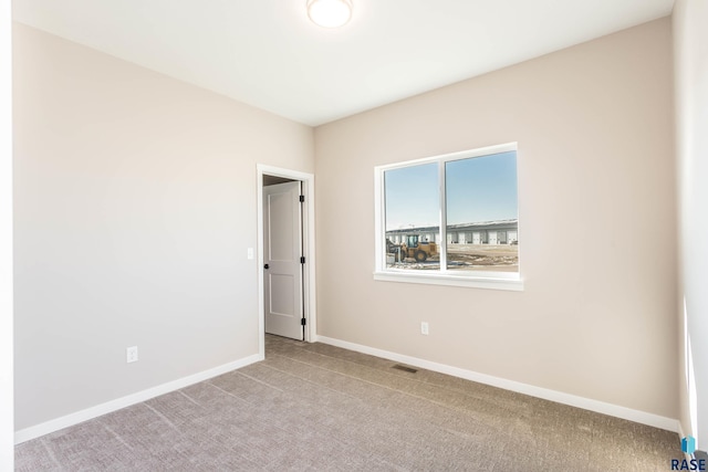 unfurnished room featuring light colored carpet