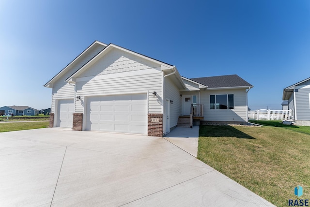 view of front of house featuring a garage and a front lawn