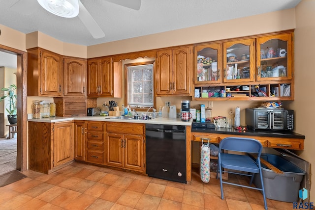 kitchen featuring dishwasher, a textured ceiling, ceiling fan, and sink