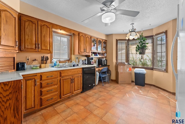 kitchen with ceiling fan, sink, black dishwasher, a textured ceiling, and light tile patterned floors