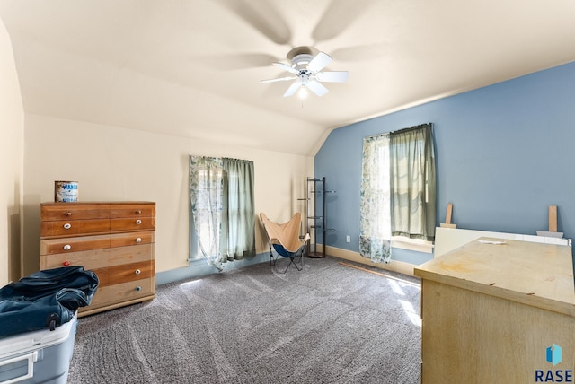 interior space featuring ceiling fan, carpet, and vaulted ceiling