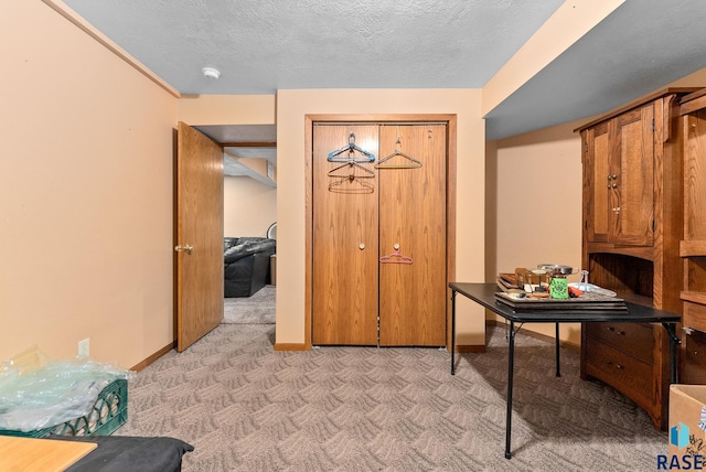 carpeted foyer entrance featuring a textured ceiling