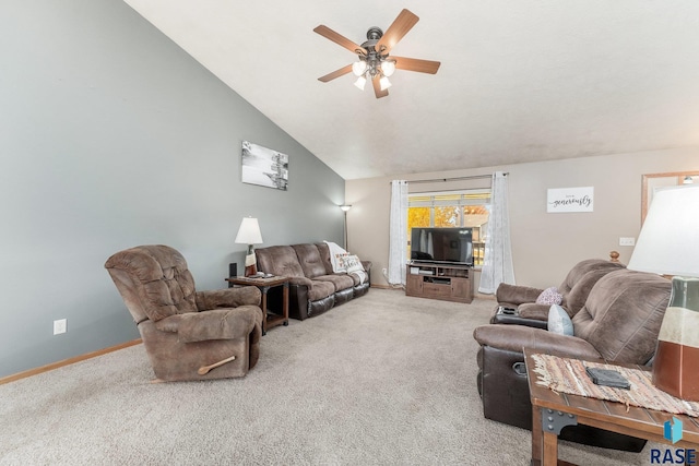 carpeted living room with ceiling fan and vaulted ceiling