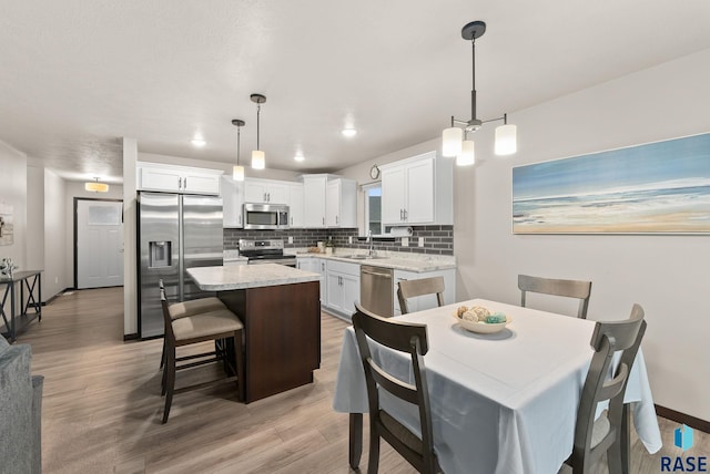 dining area with hardwood / wood-style floors and sink