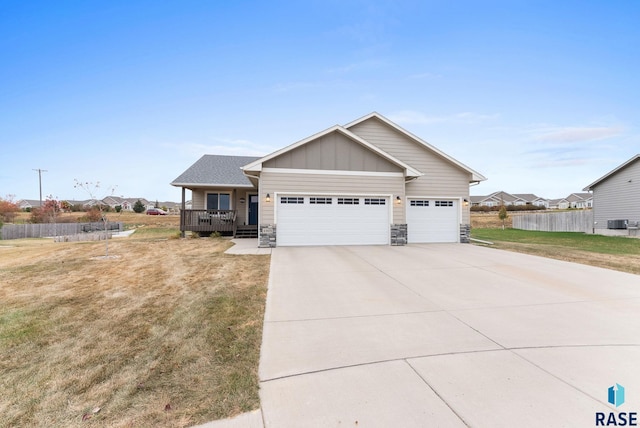 craftsman-style home featuring a garage, covered porch, and a front lawn