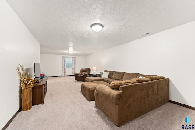 living room featuring a textured ceiling and light colored carpet