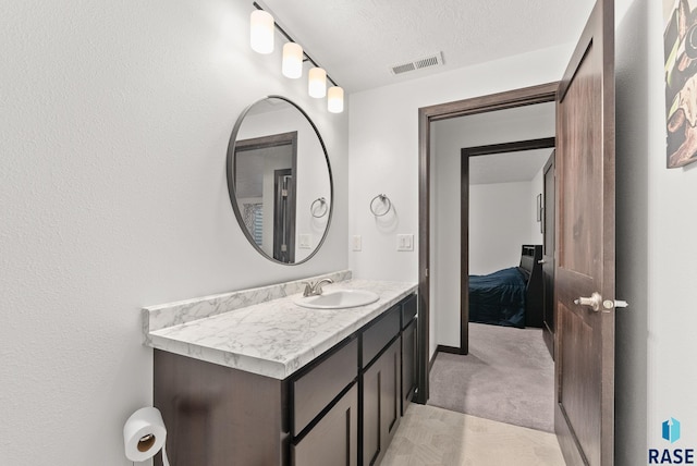 bathroom with vanity and a textured ceiling