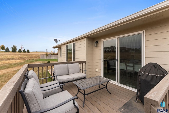 wooden deck with outdoor lounge area and area for grilling