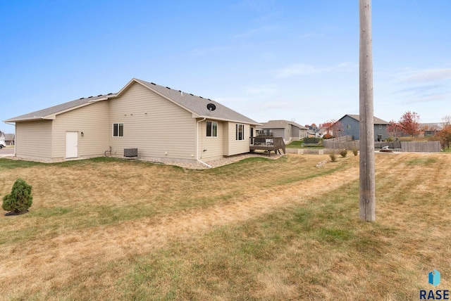 view of property exterior with a wooden deck and a lawn