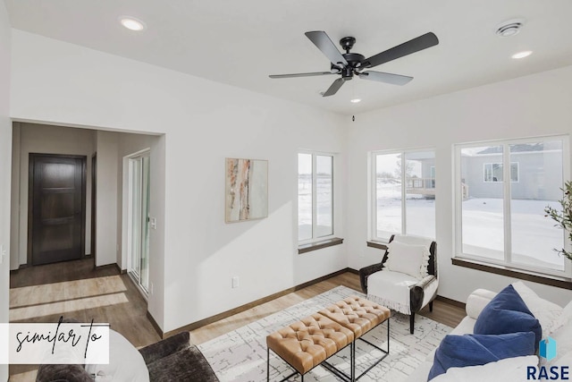 living room featuring hardwood / wood-style floors and ceiling fan