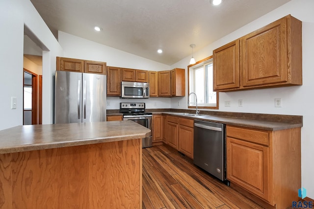 kitchen with sink, dark hardwood / wood-style floors, decorative light fixtures, lofted ceiling, and appliances with stainless steel finishes