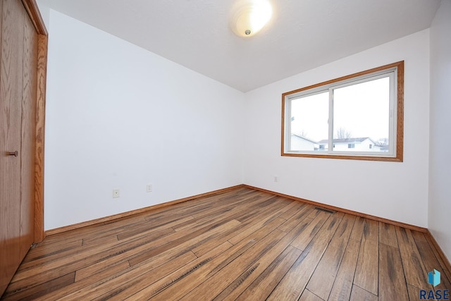 spare room with hardwood / wood-style floors