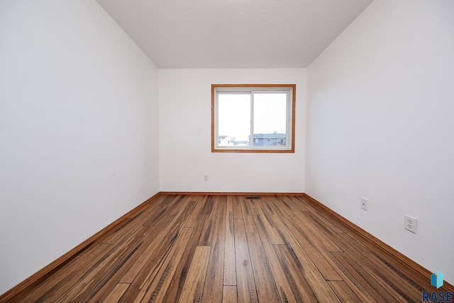 spare room with hardwood / wood-style floors