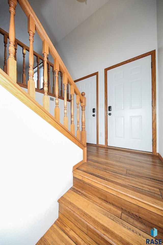 stairs featuring wood-type flooring