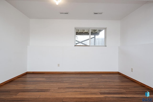 spare room with dark wood-type flooring