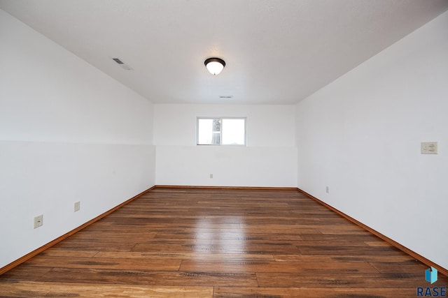 spare room with dark hardwood / wood-style flooring