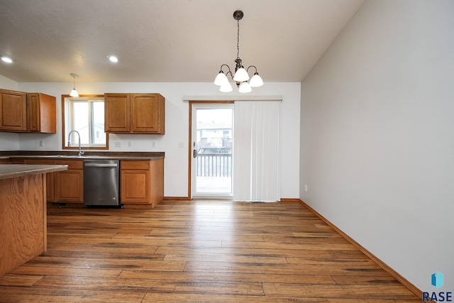 kitchen with stainless steel dishwasher, a notable chandelier, pendant lighting, and dark hardwood / wood-style flooring