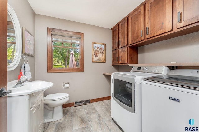 laundry area with independent washer and dryer and sink