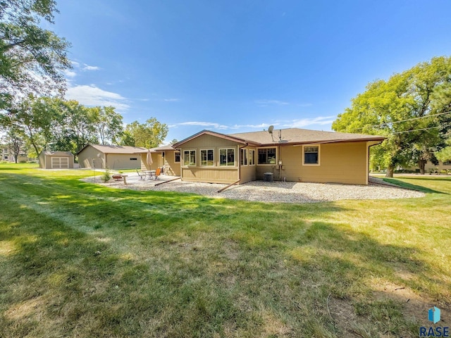 rear view of property with a lawn and a patio area