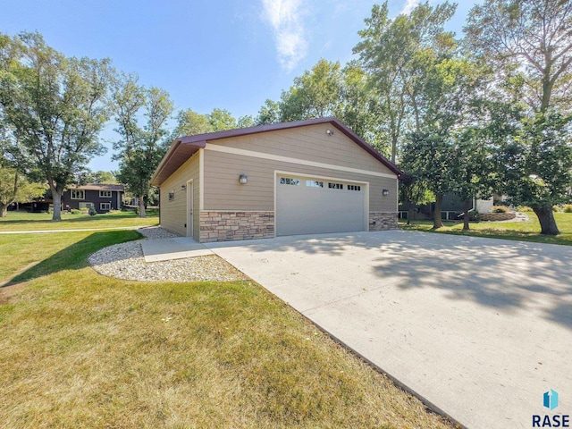 view of property exterior with a yard, an outdoor structure, and a garage