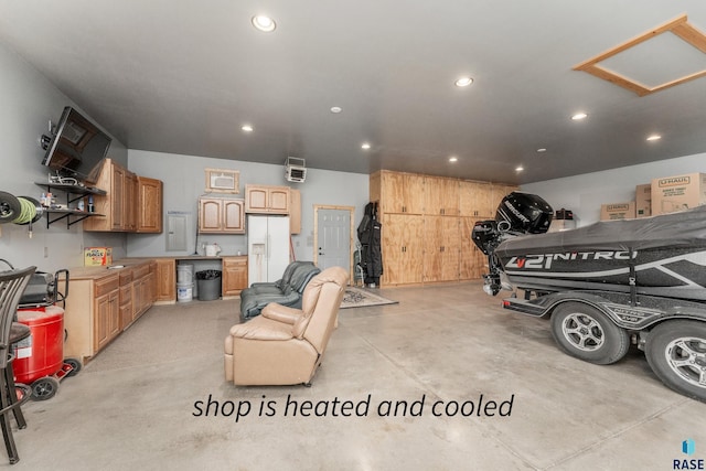 garage featuring white refrigerator with ice dispenser